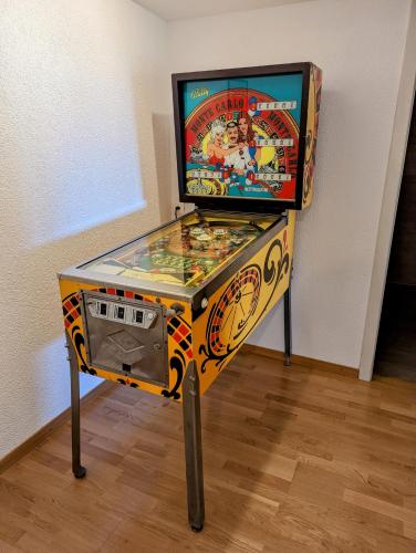 a pinball machine with a video game on it at Domaine de la Crausaz in Grandvaux