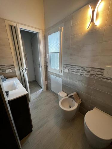 a bathroom with a toilet and a sink at Marinella House in Sarzana