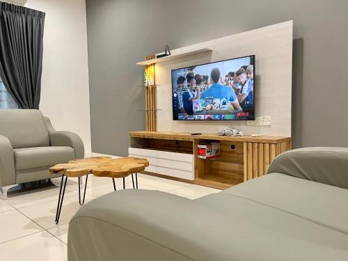 a living room with a tv and a couch at Langkawi Cozy Holiday Home at Taman Simfoni by Zervin in Kuah