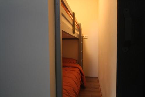 a small bedroom with a bed in a closet at Logement In de Peel in Griendtsveen
