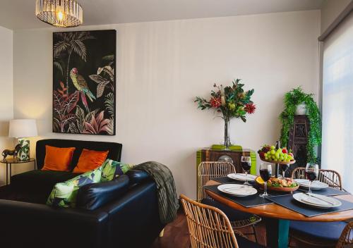 a living room with a table and a couch at Hobart Rose Court Apartments "Avitium" in New Town