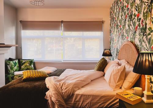 a bedroom with a bed in front of a window at Hobart Rose Court Apartments "Avitium" in New Town