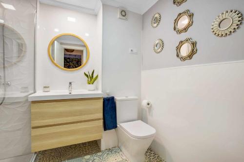 a bathroom with a sink and a toilet and a mirror at MÁlaga Playa in Málaga