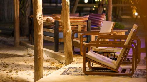 a group of chairs sitting on a patio at The Mida Creek Hotel in Watamu