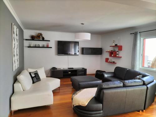 a living room with a couch and a chair at Villa Fanny in Ribeira Brava