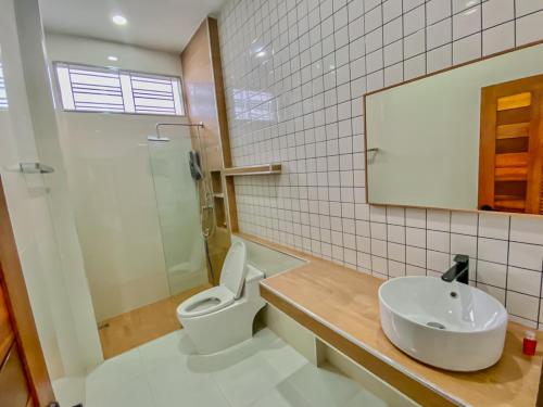 a bathroom with a toilet and a sink at In Town Pool Villa Krabi in Ban Khlong Chi Lat