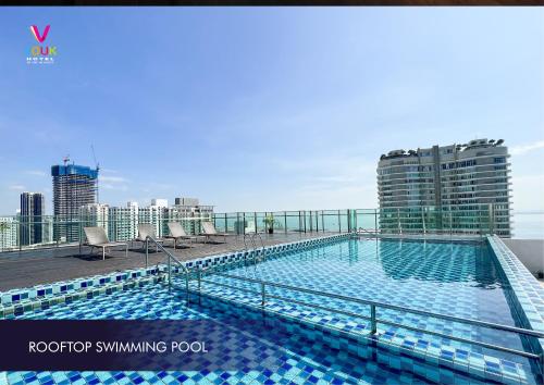 a swimming pool on the roof of a building at Vouk Hotel Suites, Penang in George Town