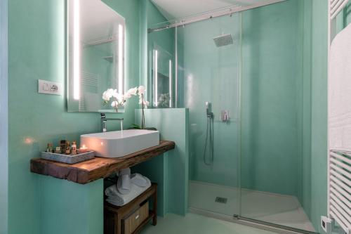 a bathroom with a sink and a shower at Villa Aga - Homelike Villas in Cingoli