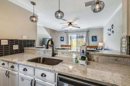 a kitchen with a sink and a ceiling fan at 1BR Townhouse on Okaloosa Island - 5 Min Walk to Beach! Near Restos! in Fort Walton Beach
