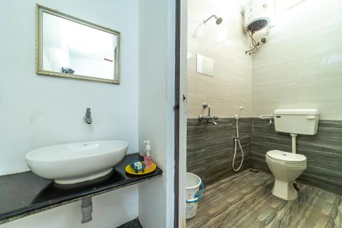 a bathroom with a sink and a toilet at RAINBOW RESIDENCY ECR in Auroville