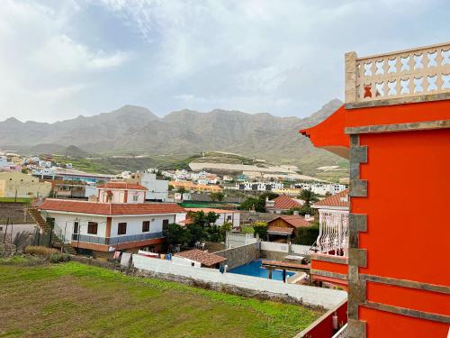 a view of a city with mountains in the background at Hotel La Aldea Suites in La Aldea de San Nicolas