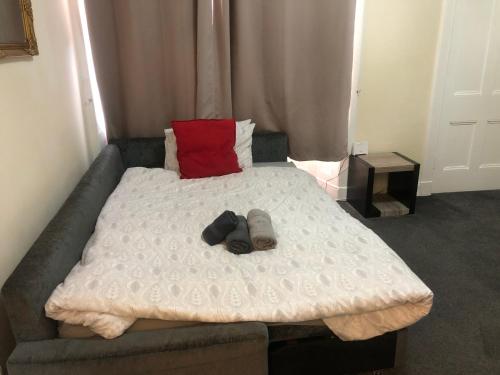 a bed with two shoes on it in a room at Beautiful Apartment near Edinburgh in Dunfermline