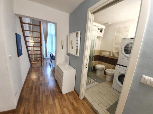 a bathroom with a washing machine and a washer at Casa Marsili - Luxury Apartment in Turin