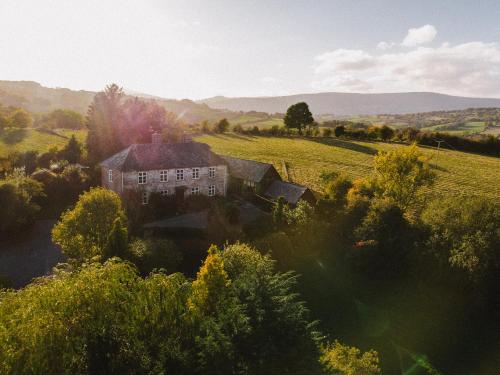 an aerial view of a house in a field at Beautiful farmhouse near Abergavenny - Sleeps 6-26 in Grosmont