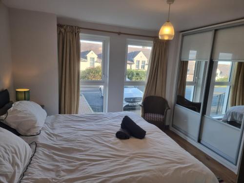 a bedroom with a bed and a large window at Harbour View Townhouse in Portrush