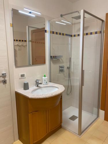 a bathroom with a sink and a shower at Al Tiglio Rooms in La Valle