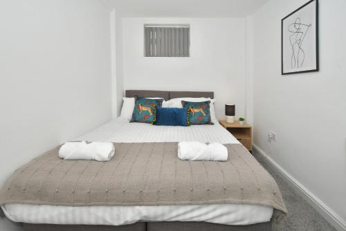 a bedroom with a large bed with two pillows at Hanford Apartments in Stoke on Trent