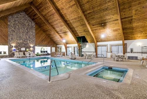 a large swimming pool in a building with a wooden ceiling at Jackson Inn in Jackson