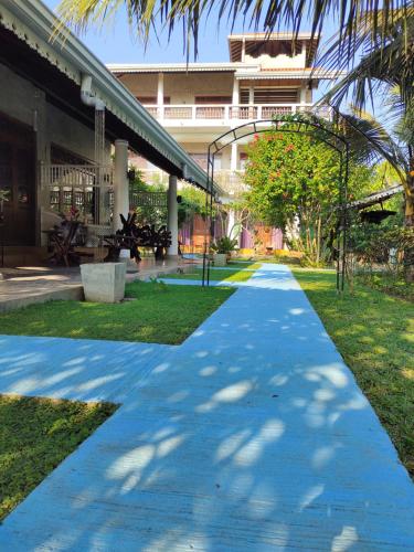 a walkway in front of a building at Thambili Cabanas in Hikkaduwa