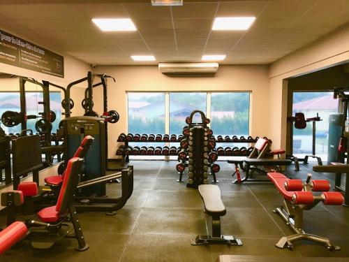 a gym with a lot of equipment in a room at L'Eskale Guyane in Montjoly