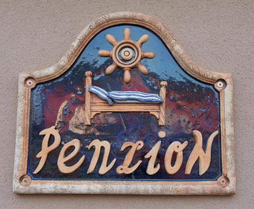 a sign on a wall with a sign for a room at U Námořníka-Restaurant a penzion in Hukvaldy
