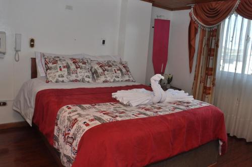 a bedroom with a bed with a swan on it at Hotel Suite Imperial in Tunja