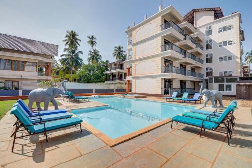 two elephants statues standing next to a swimming pool at Luxurious Villa with Private Swimming Pool, Kids Pool, Games, Private Parking in Calangute