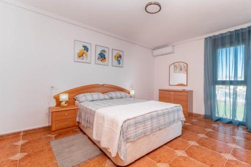 a bedroom with a large bed and a window at Espanatour PLAYA FLAMENCA in Orihuela Costa