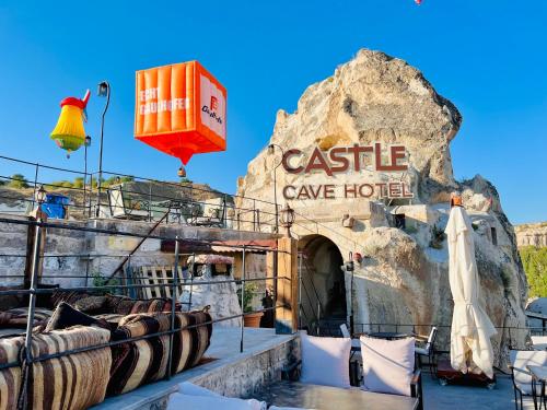 a sign for a castle cave hotel on a rock at Castle Cave Hotel in Göreme
