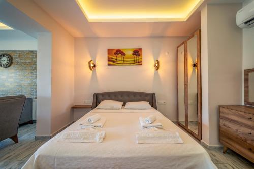 a bedroom with a bed with two towels on it at Nakas Suites in Fethiye