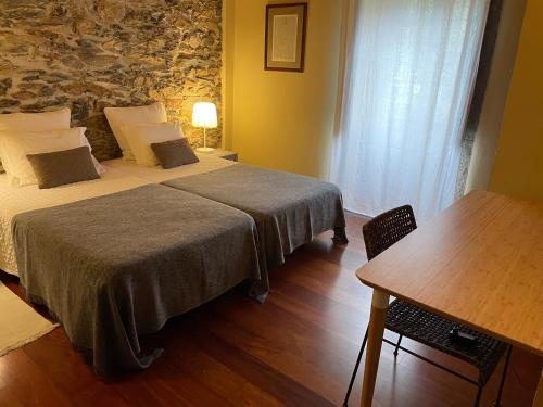 Ένα ή περισσότερα κρεβάτια σε δωμάτιο στο Casa das Quintas