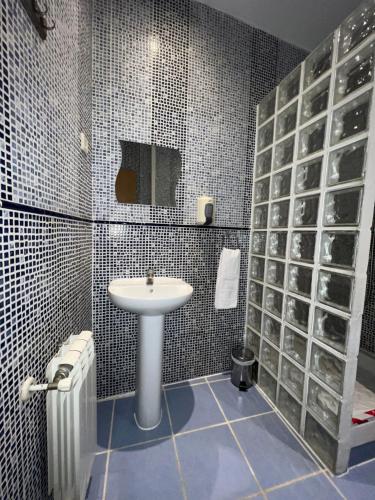 a bathroom with a sink and a mirror at Hostal La Casa de La Plaza in Madrid