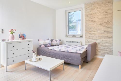 a small bedroom with a bed and a table at Ferienhaus Ostsee in Dorf Mecklenburg