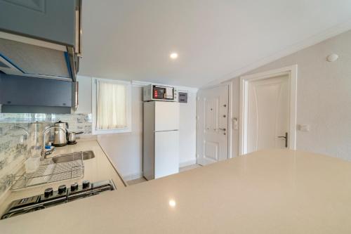 a kitchen with a counter top and a refrigerator at Nakas Suites in Fethiye