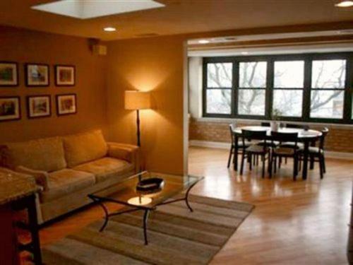 a living room with a couch and a table at Roscoe Village Guesthouse in Chicago