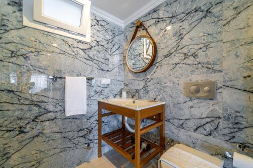 a bathroom with a sink and a mirror at Nakas Suites in Fethiye