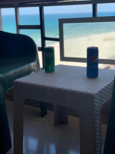 a coffee table with two cups on top of it at Alzohour Family condo with panoramic sea view in Alexandria