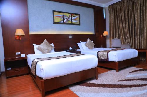 a hotel room with two beds in a room at Sidra International Hotel in Addis Ababa
