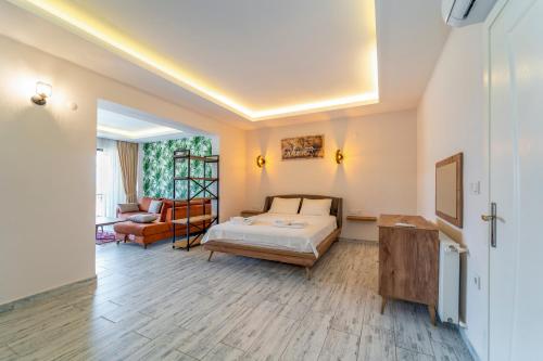 a bedroom with a bed and a living room at Nakas Suites in Fethiye
