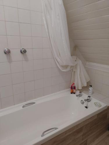 a bathroom with a white tub and a sink at Yellowwood Lodge in Knysna