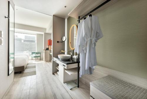 a bathroom with a sink and a mirror at Centara Grand Hotel Osaka in Osaka