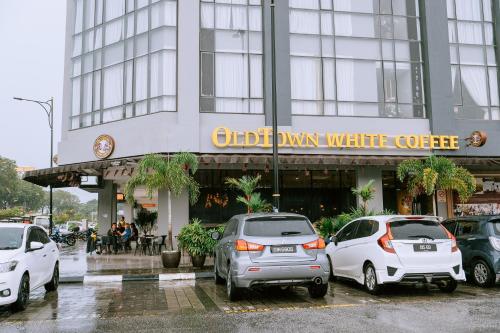 a group of cars parked in front of a building at Chill Suites Langkawi in Kuah