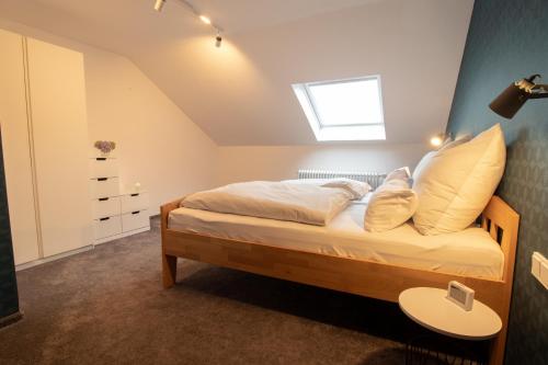 a bedroom with a bed with a skylight at Ferienwohnung Fischer in Holzmaden
