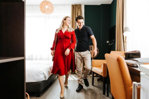 a man and a woman standing in a room at The Hague Teleport Hotel in The Hague