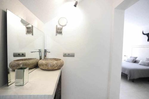 a bathroom with two sinks on a counter at Balinese Villa near the beach outdoor jacuzzi in Cala Llonga