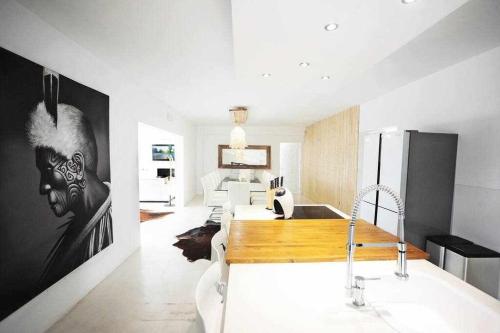 a kitchen with a sink and a kitchen with a refrigerator at Balinese Villa near the beach outdoor jacuzzi in Cala Llonga