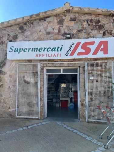 a store with a sign on top of a building at CASA SIBILLA bi-locale con terrazza a 60 metri dal mare in Marinella