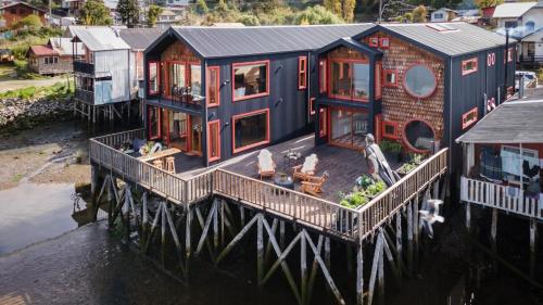 an aerial view of a house on a pier at Bledford Chiloé in Castro