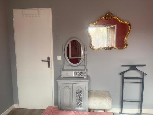 a mirror on a wall next to a door at ELLO HAPPINESS HOME place to be in pau in Pau
