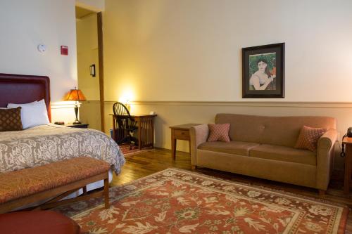 a hotel room with a bed and a couch at The Common Man Inn & Restaurant in Claremont